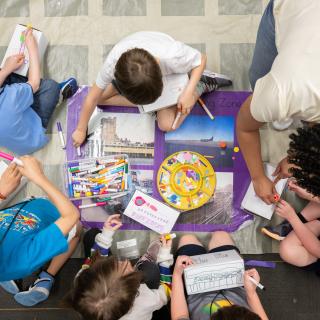 A group of students participating in an art making activity. 